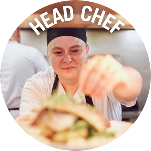 Head chef adding garnish to dish. Link to Head Chef Jobs