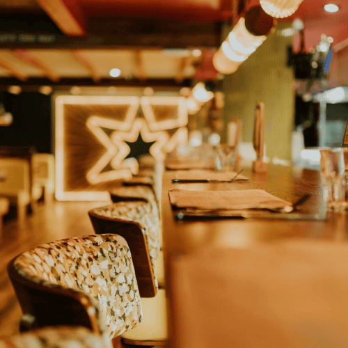 an image of a Browns drinks menu on a brass bar table